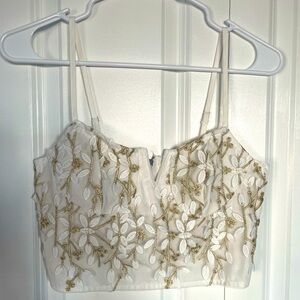 Women’s top. Cropped adjustable straps with back zipper. Size XS.